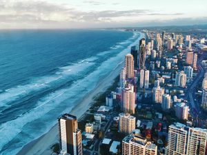 Stunning aerial view of Gold Coast, QLD, showcasing its skyscrapers and beautiful beach at daylight.